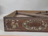 a small wooden box with a decorative design on it