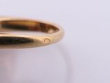 a close up of a gold ring with a diamond on it