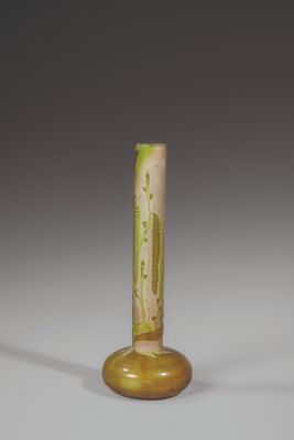a yellow vase with a green design on it