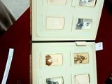 an open book with pictures of people in it on a table