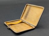 a small metal case with a yellow handle on a table