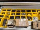 many different types of screws and nuts in a drawer