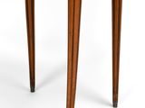 a round wooden table with two drawers and a drawer underneath it