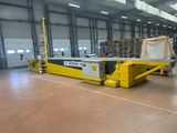 a picture of a warehouse with pallets and a conveyor belt