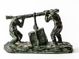 statue of two men carrying a large piece of wood on a rock
