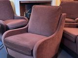 two chairs that are sitting in front of a fire place
