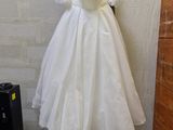 a dress hanging on a mannequin in the corner of a room