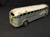a toy bus that is sitting on a black surface