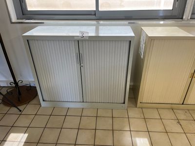 a picture of a kitchen with a white cabinet and a window