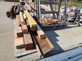 many pieces of wood sitting on the ground next to a pile of other wood