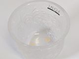 a clear bowl with a small yellow object in it