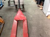 a forklift in the middle of a warehouse with pallets