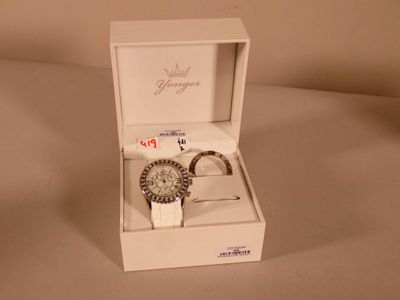a white box with a watch inside of it on a table