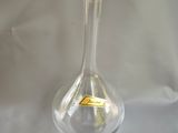 a glass vase with a butterfly on it on a table