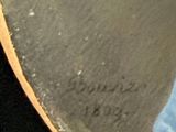 a close up of a person holding a skateboard in their hand