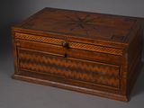an old wooden box with a star design on the lid