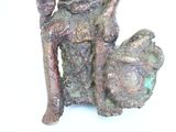 a statue of a man sitting on a chair with a dog