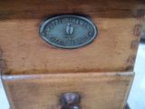 un gros plan d'une boîte en bois surmontée d'une plaque métallique