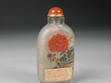 a small glass bottle with a red seal on it
