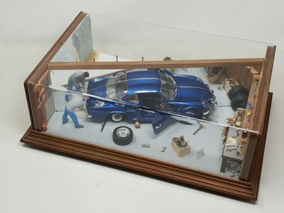 a model of a car in a glass case on a table
