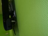 a green wall with a phone on it next to a sink