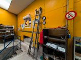 a ladder leaning up against a yellow wall in a room