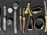 a lot of watches that are laying out on the table