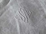 a napkin with a monogram on it on a table