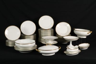 a lot of white and gold plates and bowls on a black background