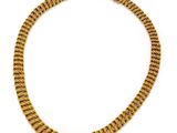 a gold chain necklace on a white background