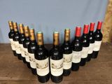 several bottles of wine are lined up in a row on a wooden table