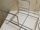 a white table with a metal tray and a glass holder on it