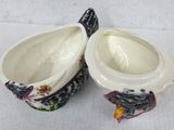 pair of porcelain bowls with birds on them on a white surface