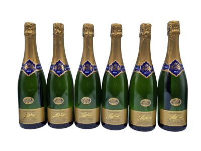six bottles of champagne are lined up in a row