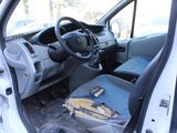 the interior of a car with the door open and a bag in the passenger seat