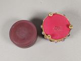 pair of pink and gold jewelry boxes on a gray surface