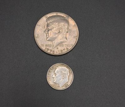 a close up of two coins on a black surface