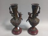 pair of antique bronze vases with birds on them on wooden bases