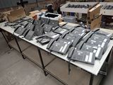 a lot of telephones sitting on a table in a warehouse