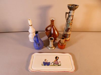 three vases and a tray on the table