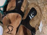 two pairs of sandals with numbers on them on the floor
