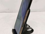 a cell phone that is on a stand on the table