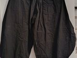 a pair of black pants hanging on a wall