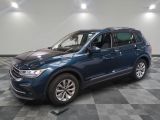 the blue volkswagen suv is parked on a checkered tile floor