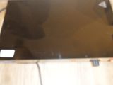 a laptop computer sitting on top of a wooden table