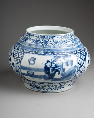 a blue and white vase sitting on a table