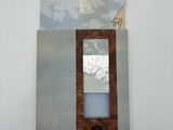 painting on the wall of a room with a window and a mirror