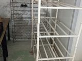 a rack of wine bottles in the corner of a room