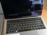 a laptop computer sitting on a table with a note on it