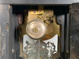 a clock that is sitting in the corner of a room